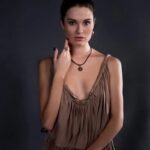 How to Clean Silver Jewelry With Gemstones Sterling silver bracelet with gemstones being cleaned using a gentle silver jewelry cleaning solution