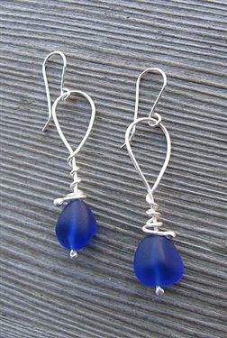 Sleek diamond earrings shimmering on display, learn how to determine the authenticity of real diamond jewelry