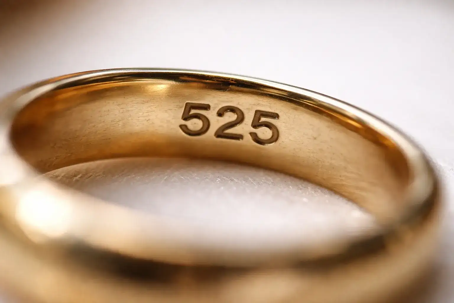 What Does 525 On Jewelry Mean Close-up photograph of 525 hallmark stamp on gold ring showing purity mark_risultato