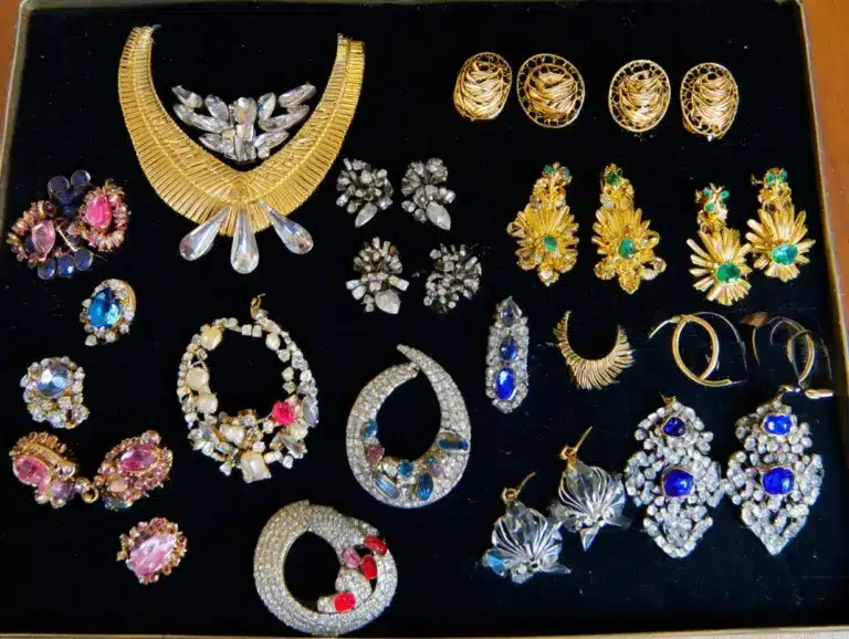 Collection of vintage costume jewelry makers marks including Trifari, Haskell, and Eisenberg